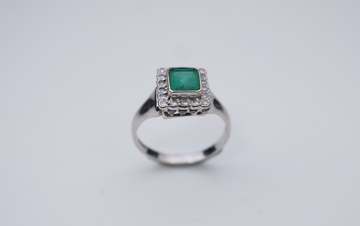 An emerald and diamond ring